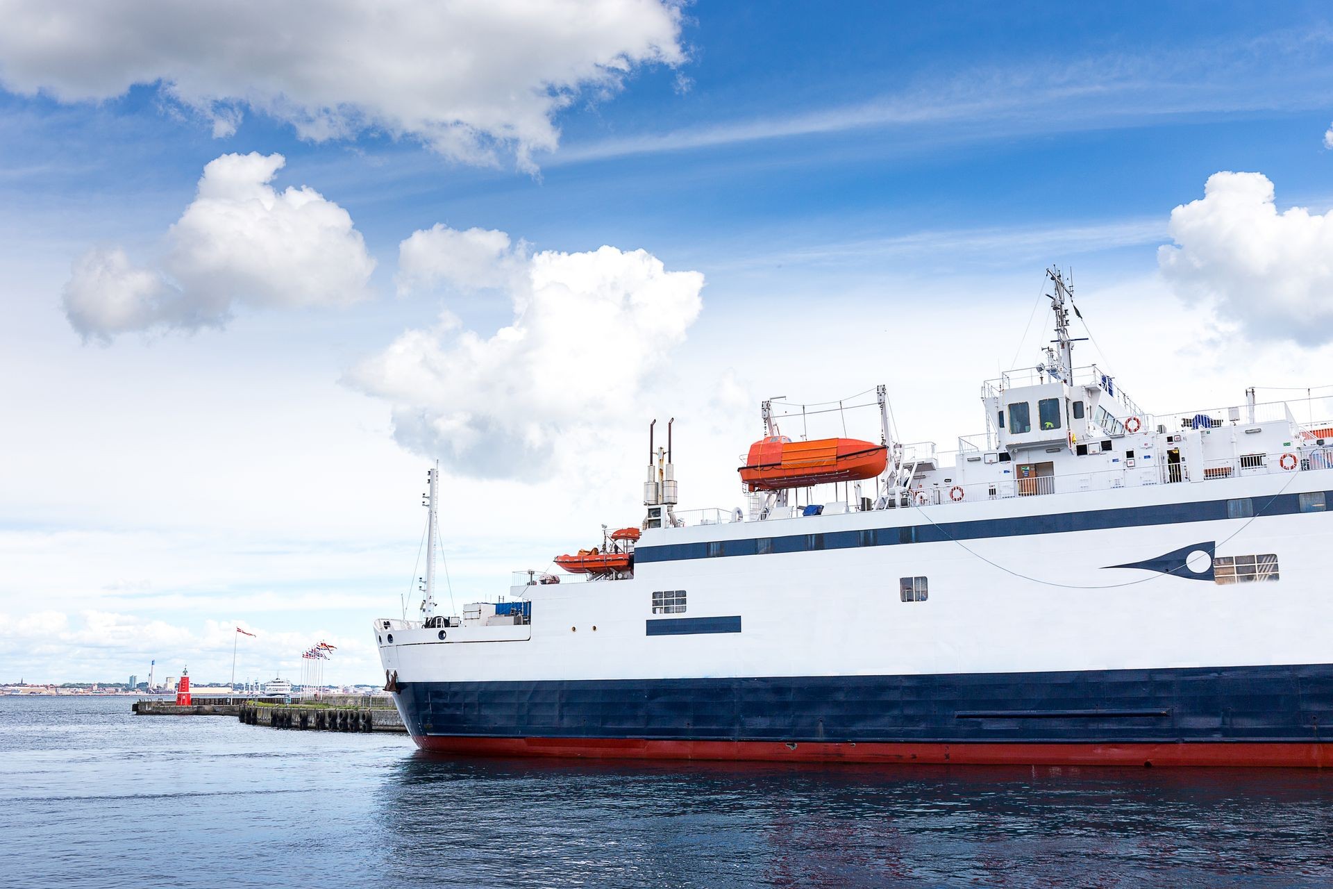 Modern and luxury ferry boat at harbor for across the sea from Helsingor north of Copenhagen, Denmark to Helsingbor, Sweden with blue sky and cloud